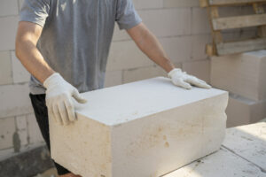 aerated concrete blocks on a house foundation, ensuring precise alignment and stability for the building structure.